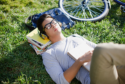 college student relaxing on grass